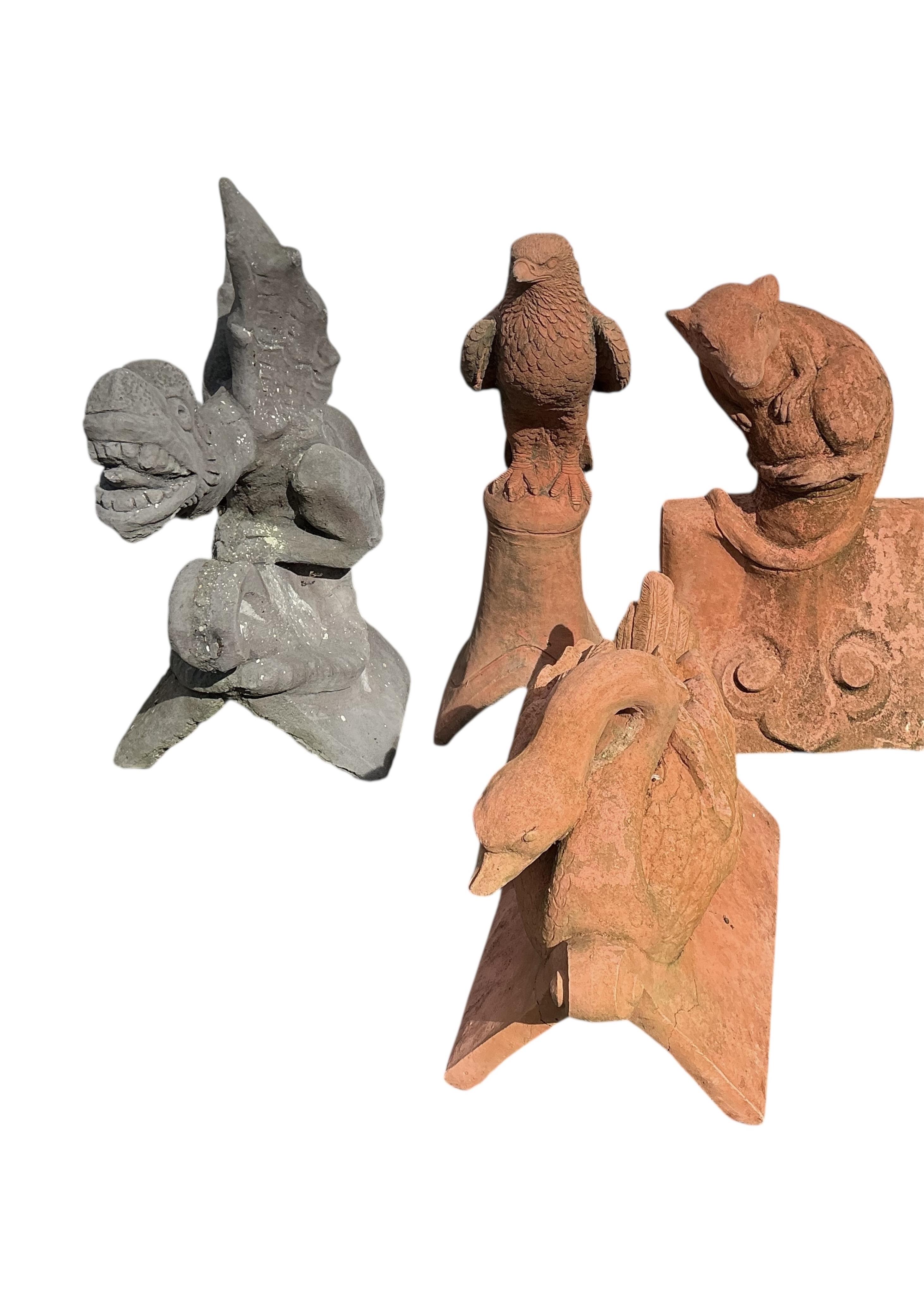 Four cast stone ridge tiles, largest height 56cm